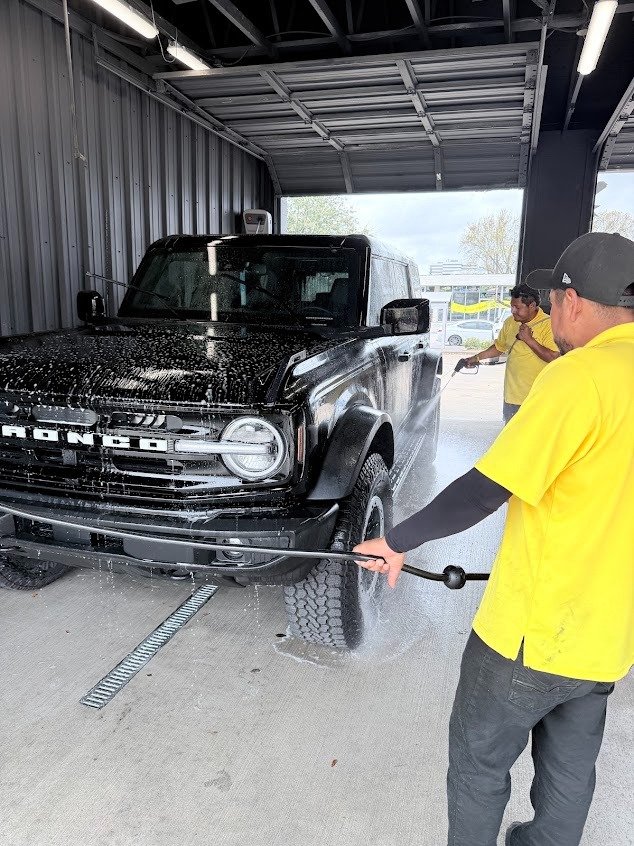Ford Bronco being rinsed by detailers at Pineapple Autospa, Houston